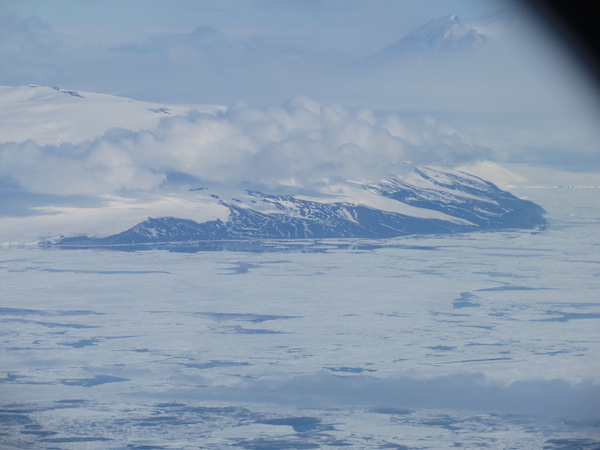 The northern tip of Ross Island. Cape bird AWS is located here on the coast, near the far left of the picture on rock. Part of Mount Erebus can be seen in the upper right corner.