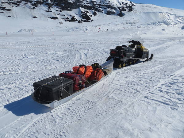 One of the sled-wielding snowmobiles